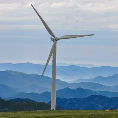 Wind turbine in front of a mountain landscape